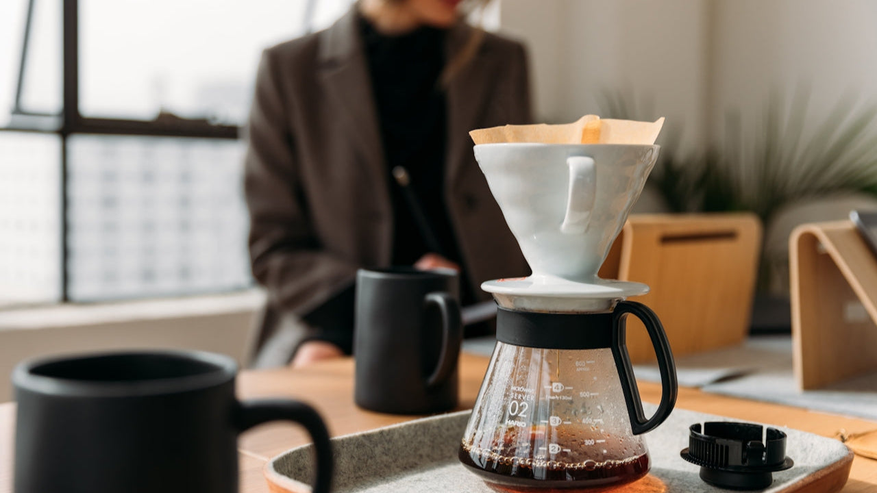 Coffee brewing process with a person in the background